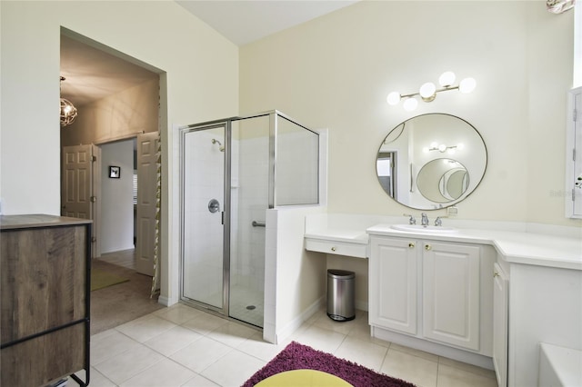 bathroom with tile patterned flooring, vanity, and a shower with door