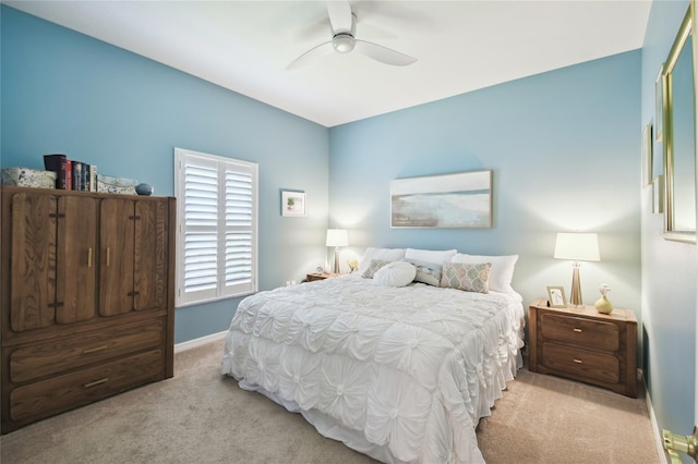 carpeted bedroom with ceiling fan and a closet