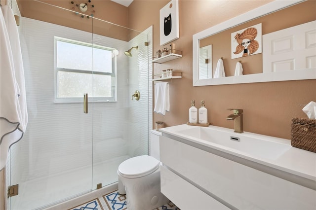 bathroom with vanity, a shower with shower door, and toilet