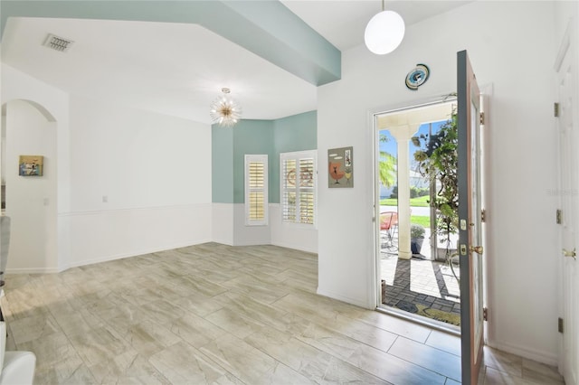 foyer entrance featuring an inviting chandelier