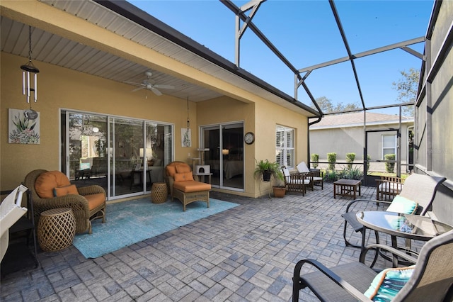 sunroom featuring ceiling fan and beam ceiling