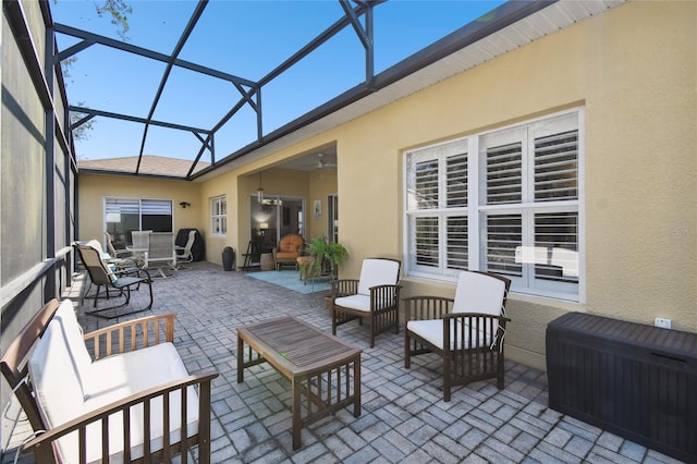 view of patio / terrace with an outdoor living space and glass enclosure