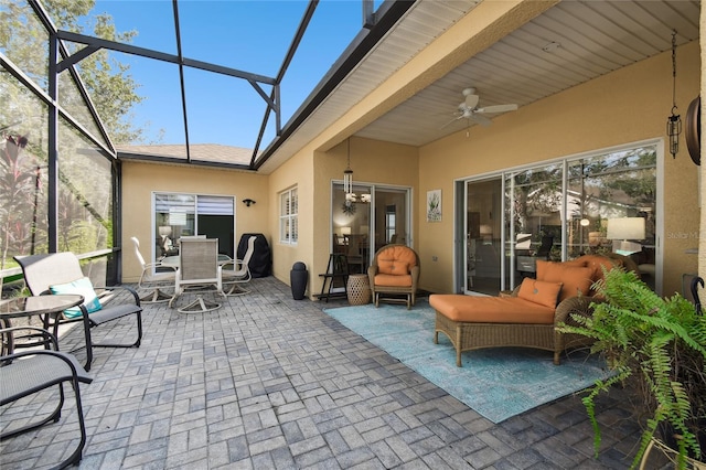 sunroom with beamed ceiling and ceiling fan