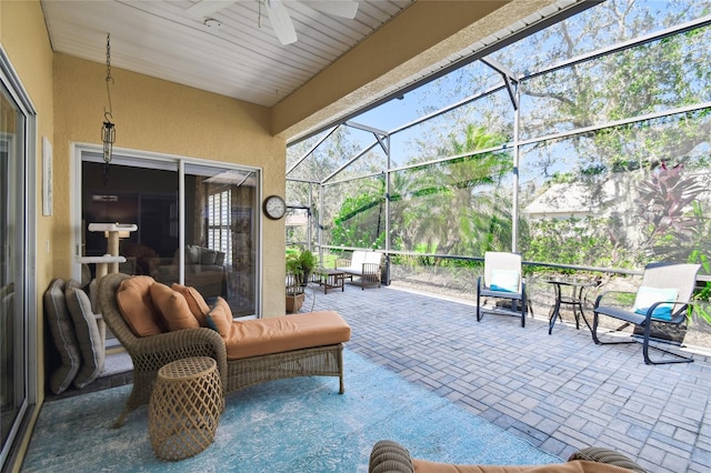 view of patio featuring ceiling fan and a lanai