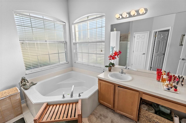 12213 Still Meadow Dr, Clermont, FL 34711 - bathroom with healthy amount of natural light, a garden tub, vanity, and a shower with door