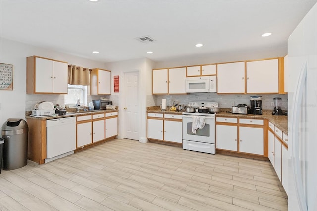 kitchen featuring light hardwood / wood-style flooring, white cabinets, white appliances, and sink