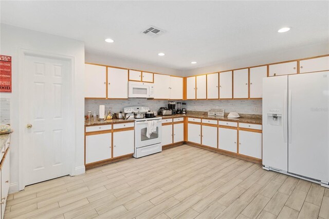 kitchen featuring white cabinetry, light wood-type flooring, white appliances, and backsplash