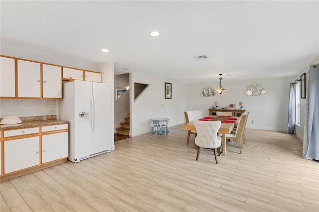 unfurnished dining area with light wood-type flooring