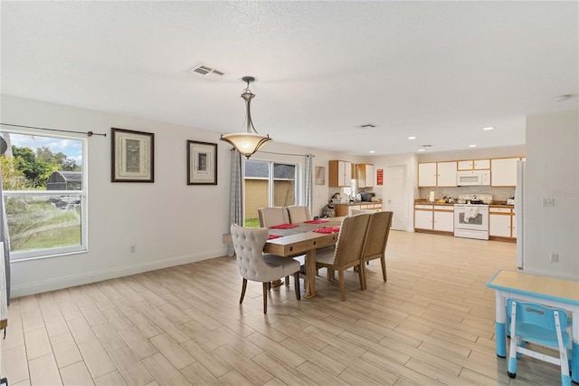 dining space with light wood-type flooring