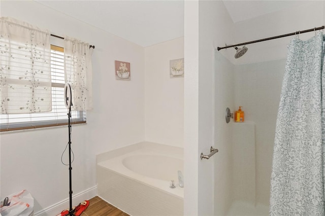 bathroom featuring hardwood / wood-style flooring and independent shower and bath