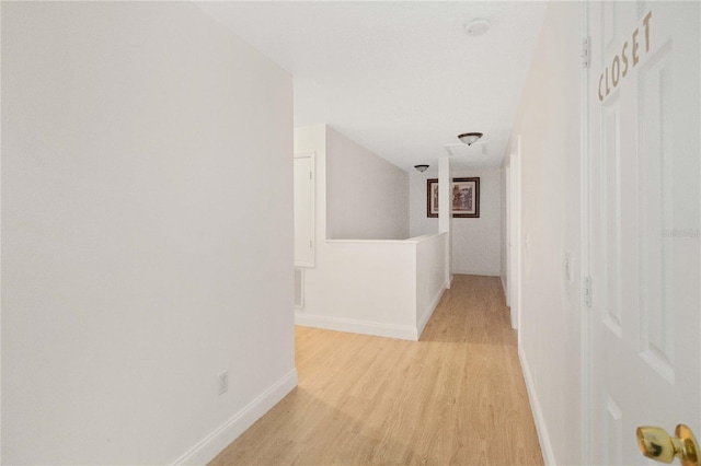 hallway with light hardwood / wood-style floors