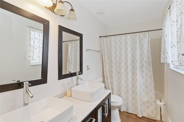 full bathroom featuring vanity, shower / bathtub combination with curtain, wood-type flooring, and toilet