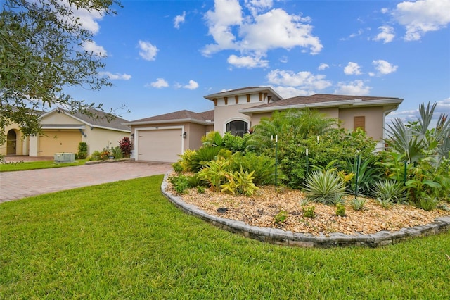 mediterranean / spanish-style home featuring a front lawn and a garage