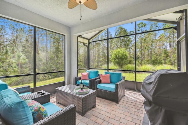 sunroom / solarium with a wealth of natural light and ceiling fan