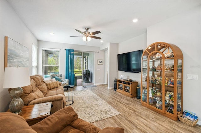 living room featuring ceiling fan and light wood-type flooring