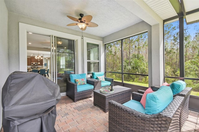 sunroom / solarium featuring ceiling fan