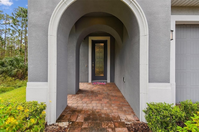 view of exterior entry featuring a garage