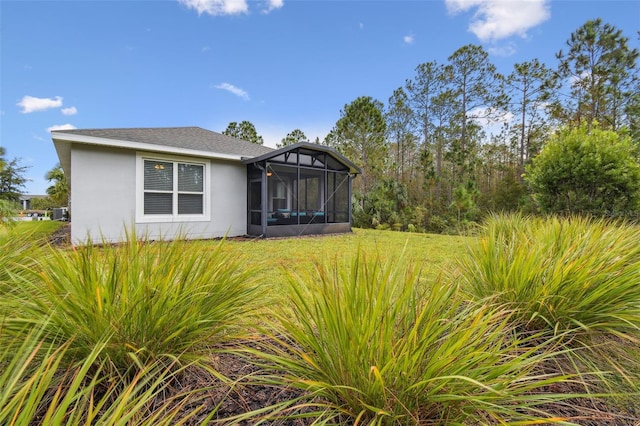 view of front facade with a front yard and a sunroom