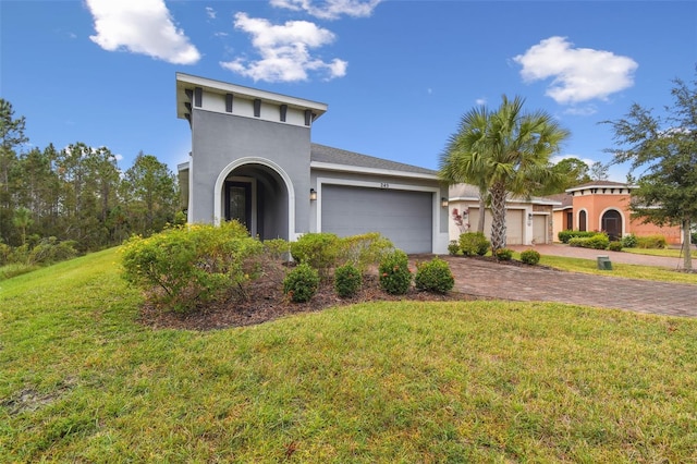 view of front of house with a front yard and a garage