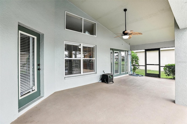 unfurnished sunroom with ceiling fan and lofted ceiling