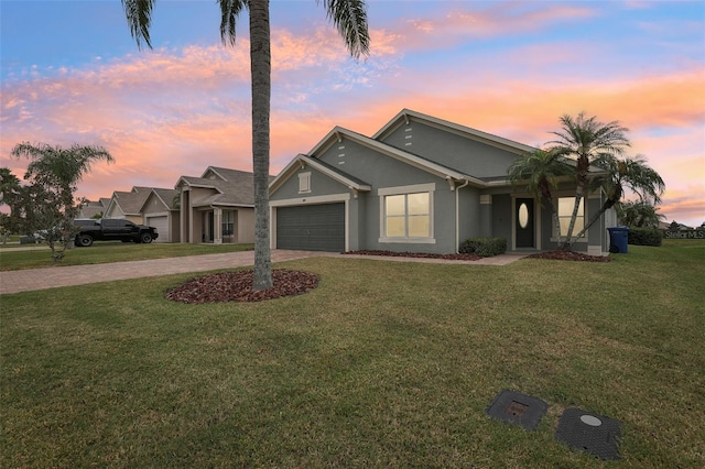 view of front facade featuring a lawn and a garage