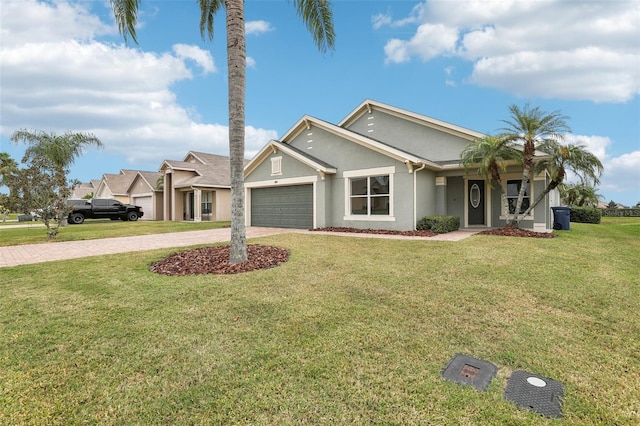 view of front of home with a garage and a front lawn