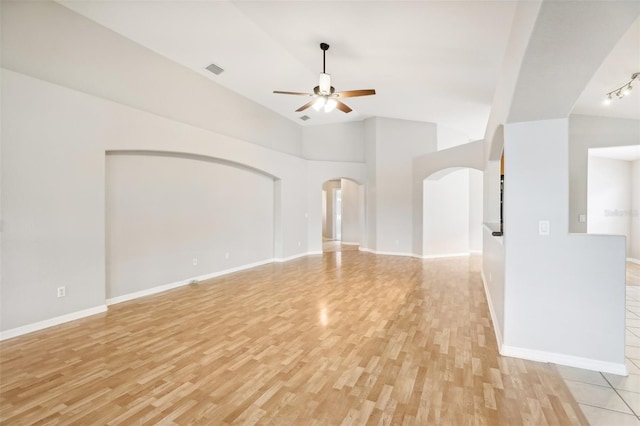 unfurnished living room featuring ceiling fan, light hardwood / wood-style flooring, and vaulted ceiling