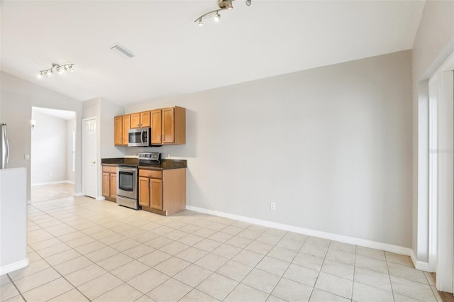 kitchen featuring light tile patterned flooring, appliances with stainless steel finishes, and track lighting