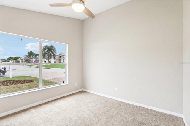 carpeted empty room with ceiling fan