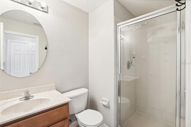 bathroom with toilet, vanity, a textured ceiling, and walk in shower