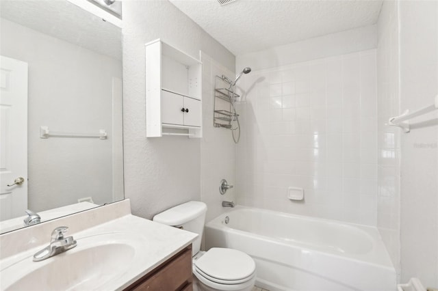 full bathroom featuring tiled shower / bath combo, toilet, a textured ceiling, and vanity