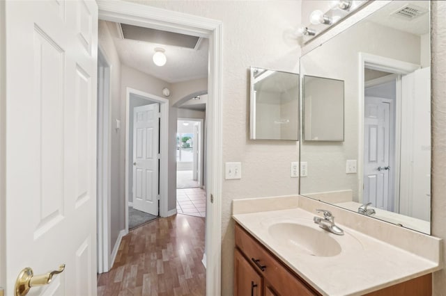 bathroom with vanity and wood-type flooring