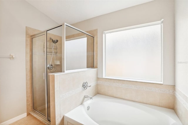 bathroom featuring tile patterned floors and independent shower and bath