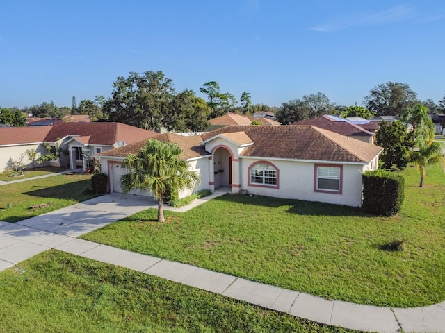 ranch-style home with a front yard and a garage