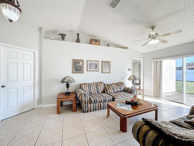 tiled living room with a textured ceiling, ceiling fan, and vaulted ceiling