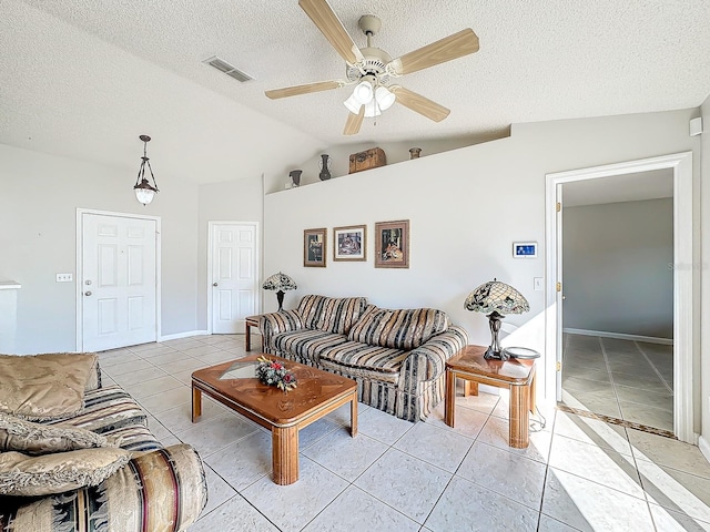 living room featuring light tile patterned floors, vaulted ceiling, and ceiling fan