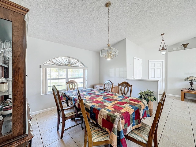 dining area with vaulted ceiling, a notable chandelier, a textured ceiling, and light tile patterned floors