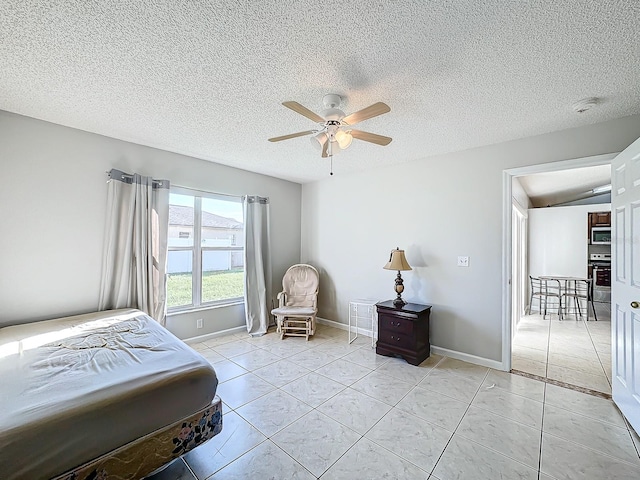 tiled bedroom with ceiling fan, a textured ceiling, and vaulted ceiling