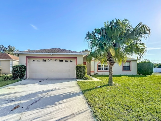 view of front of home with a front lawn and a garage