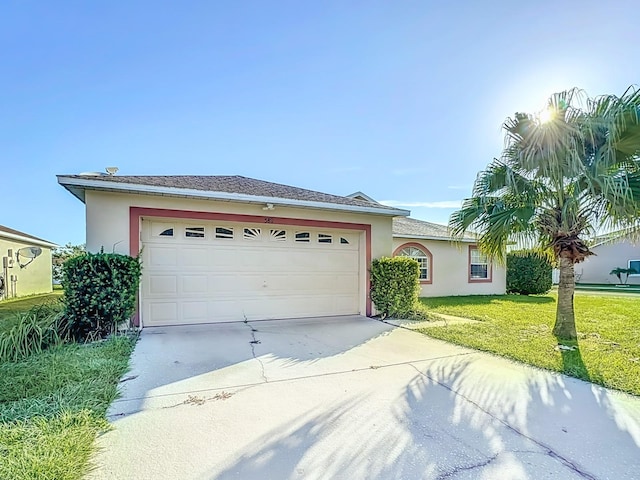 single story home featuring a front yard and a garage