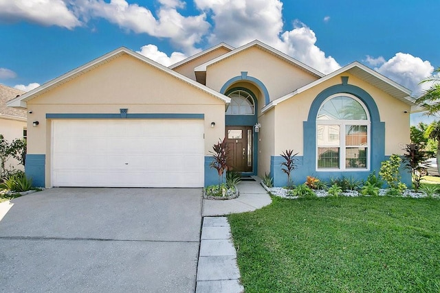 view of front of house featuring a garage and a front lawn