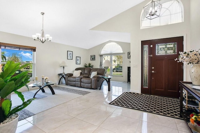 entrance foyer featuring light tile patterned floors, lofted ceiling, a wealth of natural light, and an inviting chandelier