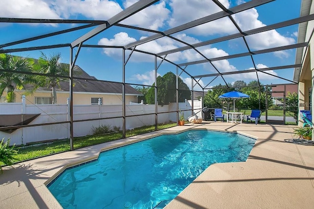 view of pool featuring a patio area and glass enclosure