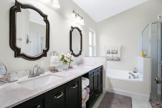 bathroom featuring vanity, shower with separate bathtub, vaulted ceiling, and tile patterned floors