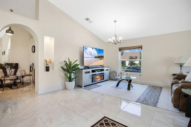 tiled living room featuring high vaulted ceiling, a chandelier, and a fireplace