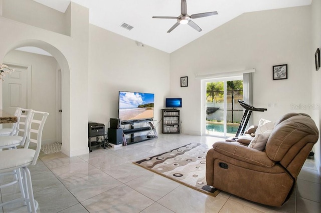 tiled living room with high vaulted ceiling and ceiling fan