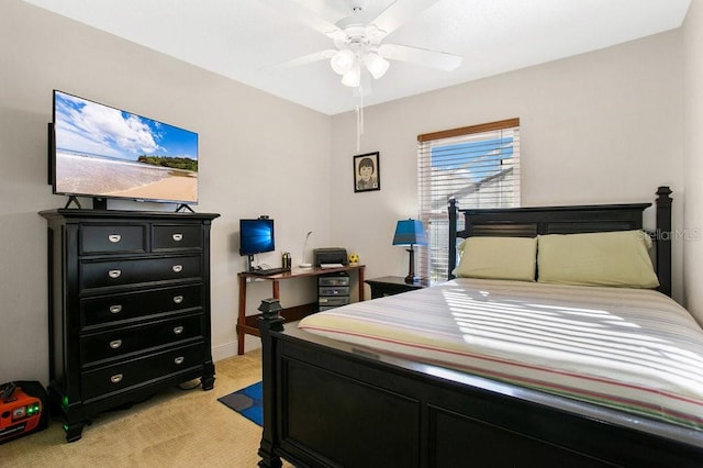 bedroom featuring light colored carpet and ceiling fan