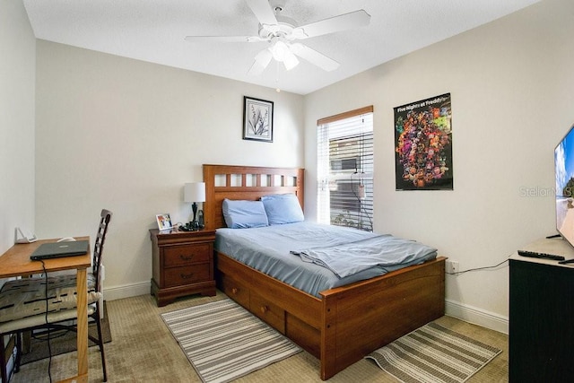 bedroom featuring ceiling fan and light colored carpet