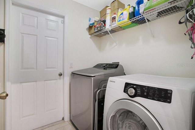 washroom featuring light tile patterned flooring and separate washer and dryer