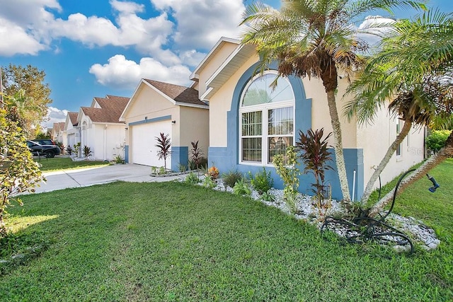 view of front facade with a front yard and a garage